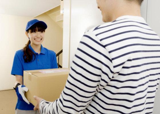 段ボールを受け取る配達員